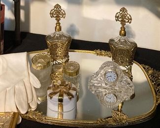 Vintage ormolu perfume bottles; trinket box; clock; gloves; tray