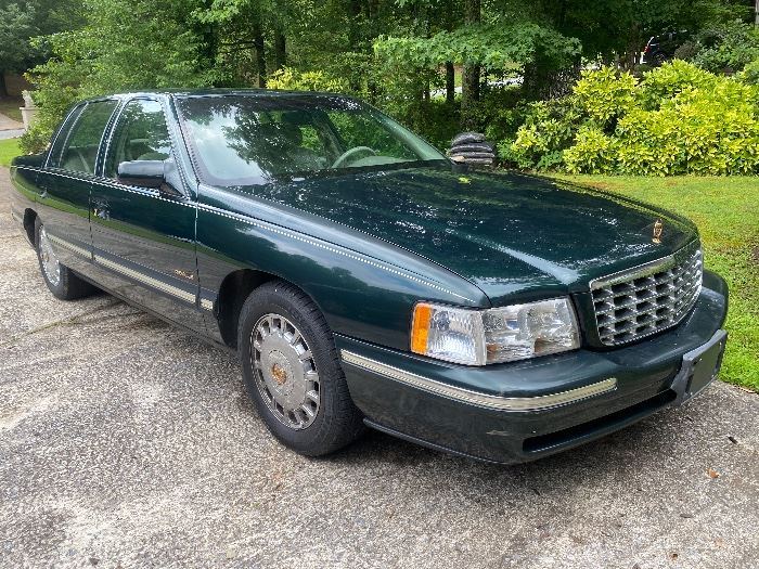 1997 Cadillac Deville
194880  miles 
Dark green with pinstripping and gold accents. 