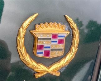 1997 Cadillac Deville
194880  miles 
Dark green with pinstripping and gold accents. 