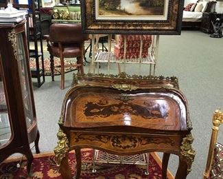 Italian style inlaid marquetry ladies desk. Cast brass gallery. Elaborate floral inlay on top, fall board, front apron, and sides. Gilt leather writing surface.