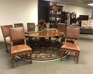 Unique round dining table with 8 barley twist leather chairs. 60 inch round dining table comfortably seats 6. Add for round extensions to create an 80 inch table with seating for 8.  Unique and impressive. Well made and very well-maintained.Shown fully extended period
