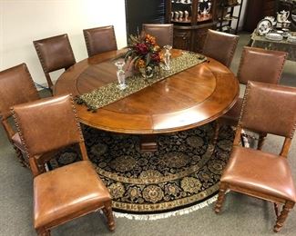 Unique round dining table with 8 barley twist leather chairs. 60 inch round dining table comfortably seats 6. Add for round extensions to create an 80 inch table with seating for 8.  Unique and impressive. Well made and very well-maintained. Shown fully extended period