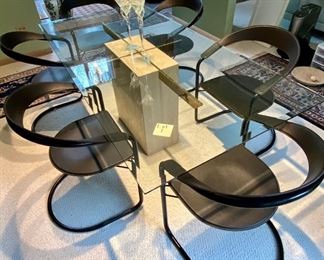 Lot #1A. Asking $525. ($1200 online) Table Only. Chairs sold in next lot. Glass Beveled Edge and Travertine Stone Base Dining Room Table, c. 1970s, With Brass Insert. Good Condition - light usage scratches, but displays well. Measures 78.5" L x 39.25"W x 27.5" H and thickness of glass abt 1/4"