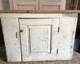Antique primitive cabinet, wood top, original chippy white paint with one shelf inside. Measures 39.5" wide, 14.25" deep and 29" high. $195