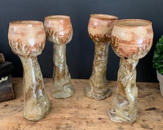 Set of 10 handmade clay chalices. There are only four shown but there are ten total. They are all clay and handturned and signed by the artist. Rust and grey in tones. No chips, Each are unique and beautiful. Each one stands. 10" tall.  $35 each. 