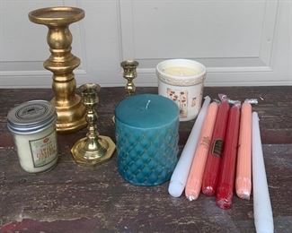 Lot of candle related. Tall decorative candlestick, two petite brass candlesticks, three pillar candles never used and six longer candles never used. Entire lot is $10