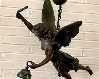 Hanging angle lamp. We have the globe to go with the light and will give to buyer. Made from a resin composite material but looks like bronze. All working order. The wand she has in her hand is bent back but can be put back forward. We will leave that to buyer as we don't want it to break. $59