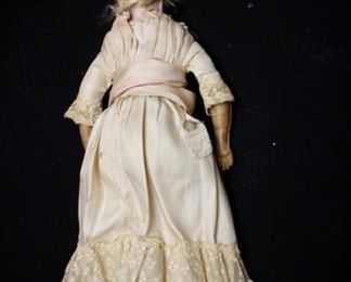 Antique Doll, Bisque head - unmarked, beautiful eyes open & close, muslin body, leather hands & boots, approx 24”	$450		