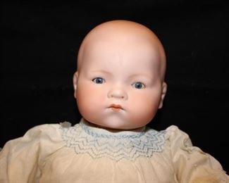 Antique AM (Armand Marseille) Baby Doll, Bisque head, eyes open & close, cloth body, cellulose hands with one finger missing, approx 17”, clothes are chewed but body is fine	$250
