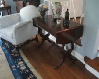 Newly upholstered antique chair with carved wood detail and Duncan Phyfe drop leaf hall table