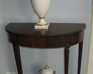 Demilune wooden table with porcelain lidded jars