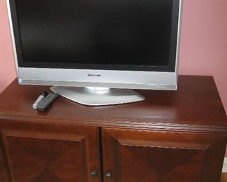 Panasonic TV on wood cabinet
