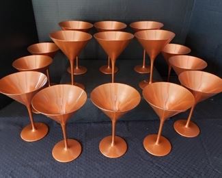 https://ctbids.com/#!/description/share/422383  15 Count: "Glisten" 6 Oz Copper Martini Glasses By Stolzle. "This martini glass features a traditional conical bowl and long, slender stem. A glistening copper color ensures a formal, yet fun, presentation, fit for trendy bars, upscale events, and festive celebrations. Use this iconic glass to serve a classic martini or any signature cocktail."
