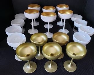 https://ctbids.com/#!/description/share/422438 8 White, 9 Gold and 6 Gold/White Cocktail Glasses. "Fit for trendy bars, upscale events, and festive celebrations. Use it to serve up sparkling champagne or creative cocktails and daiquiris in style."