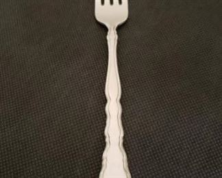 https://ctbids.com/#!/description/share/422481 "Satinique" Forks By Oneida: 12 Forks. "Subtle. Satiny. Sophisticated. This stainless flatware design inspires timeless beauty with its bright, delicately, sculpted border. A brushed, satin finish on the center panel contrasts nicely against the polished edges of the carved handle and the reflective tines and bowls. 18/10 Stainless Steel. Superb finish and pattern detail. Long lasting durability."

