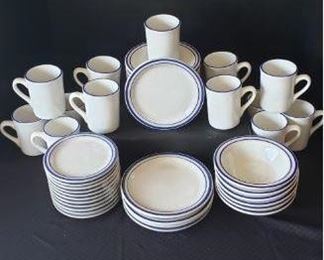 Oneida Blue Ridge: 13 cups, 6 bowls, 11 small saucers, 4 medium saucers, 11 large saucers. "These little plates were inspired by a 1960’s style, with blue specks on an ivory white base, and striped edges. The ceramic material has reinforced edges for resistance to chips. For professional food service or home dining, these charming plates have a retro appeal that all will enjoy." https://ctbids.com/#!/description/share/422379