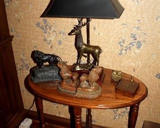 Oval side table, brass deer lamp, bookends
