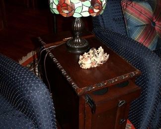 Side table with electrical outlet and built-in coasters, small leaded glass lamp