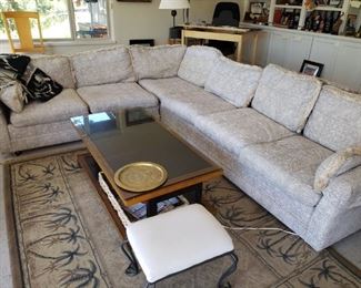 Sectional Neutral Tone sofa. Coffee Table. One of several Carpets. 