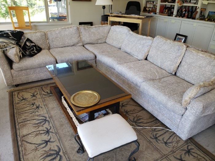 Sectional Neutral Tone sofa. Coffee Table. One of several Carpets.