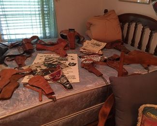 A close look at the leather holsters on the bed, posters, photos, great calendars, linens