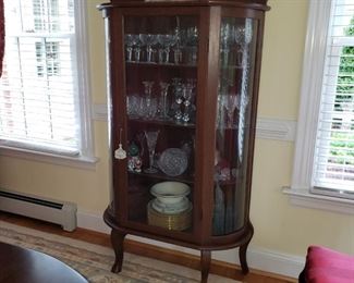 Bow Front China Cabinet  Assorted Crystal & China 