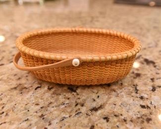 ITEM 77: Small Bill & Janet Sayles Nantucket Basket  $325
Oval basket is 6" long, 4" wide, signed on the bottom, made in 1998. Excellent condition