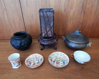 #22 - $20 - Asian Lot - (2) Tea Cups and Saucers, Black Vase, Ceramic Lided Pot, Wood base, and Candle Holder