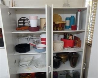 #161 - $100 - Entire contents of (2) cupboards includes Bauer pieces, vintage thermos and tupperware, brass pieces, and graniteware pieces
