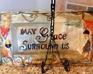 $25.  "MAY GRACE SURROUND US" GLASS TRAY ON METAL STAND.   Email us or call 512-954-3050 to buy it now or make an offer.