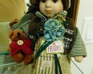 $20.  SWISS BOY DOLL HOLDING A TEDDY BEAR ON STAND.