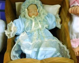 $15.  SMALL DELTON DOLL IN A CRIB
