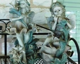 $10.  PAIR OF GARDEN FAIRIES.  SUN-FADED.