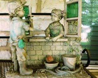 $10.   CUTE RESIN STATUE.