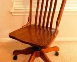 $45.  STURDY WOODEN OFFICE CHAIR ON WHEELS.