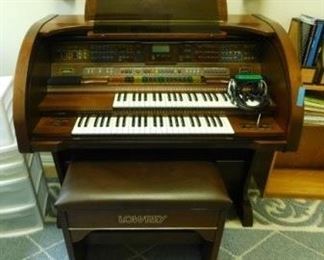 $500.  LOWREY ORGAN AND MULTIPLE SONG BOOKS.