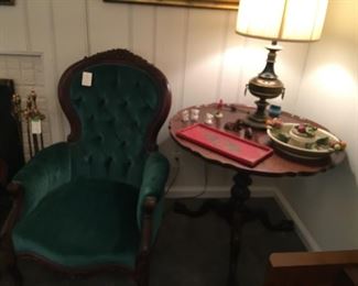 Pie crust table with claw feet. Velvet side chair.  Many nice lamps