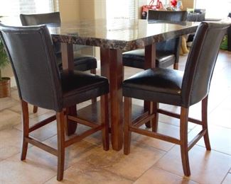 Kitchen table (47.75 sq x 35.85h) with 4 faux leather armless chairs; made in China
