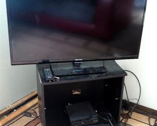 40 Inch Hisense LED LCD Television, Model 40K360, Magnavox And Funai DVD Players, And Rolling TV Stand