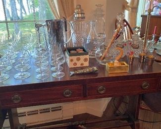 Antique mahogany drop leaf table with assorted vintage and antique bar ware