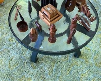 Vintage patio table with various vintage carved wood pieces.