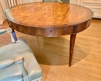 $1,600 Antique English oval mahogany writing table with inset leather top.  Approx 50"W x 43"D x 28.5"H.