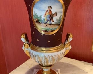 Detail of antique "Old Paris" urn with hand painted figural drawings of young boys playing.