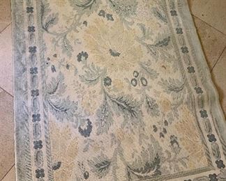 $195 Needlepoint area rug in shades of green, peach and cream.  Approx 3' x 5'.