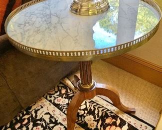 $1,650 Antique Sheridan style table marble top round table with a brass gallery; 28.5"H by 26" diameter