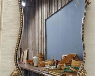 1148	CURVED, CUT MIRROR IN A SCROLL FRAME
