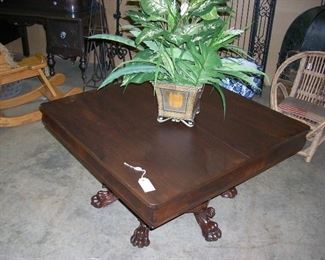 Wooden claw legged coffee table and plant
