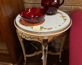 Painted antique table with glass top.