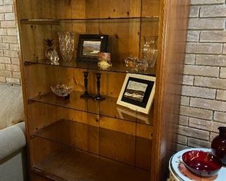 Nice wooden display unit with glass shelves and lighting.