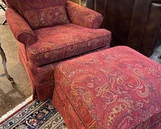 Paisley club chair with matching ottoman on casters.